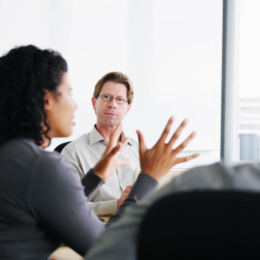 Two people in a meeting.