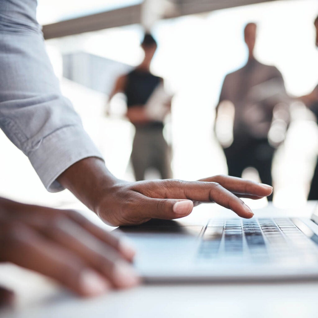 Close-up of hands on a laptop.