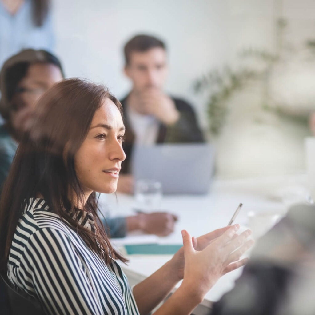 People talking in a meeting.