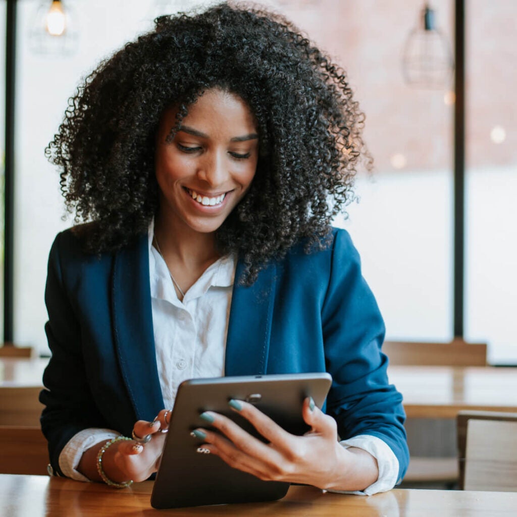 Woman working on a tablet.