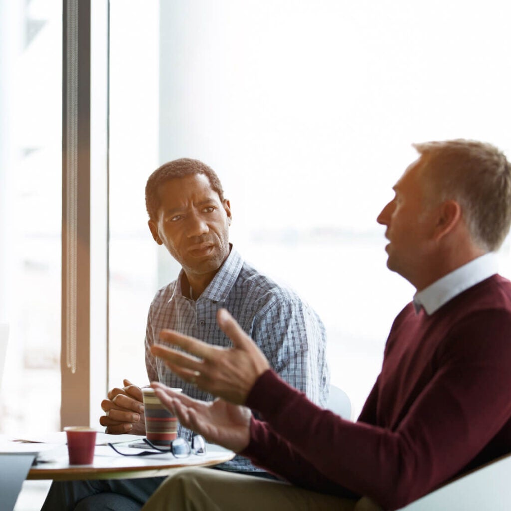 Two people in a meeting.