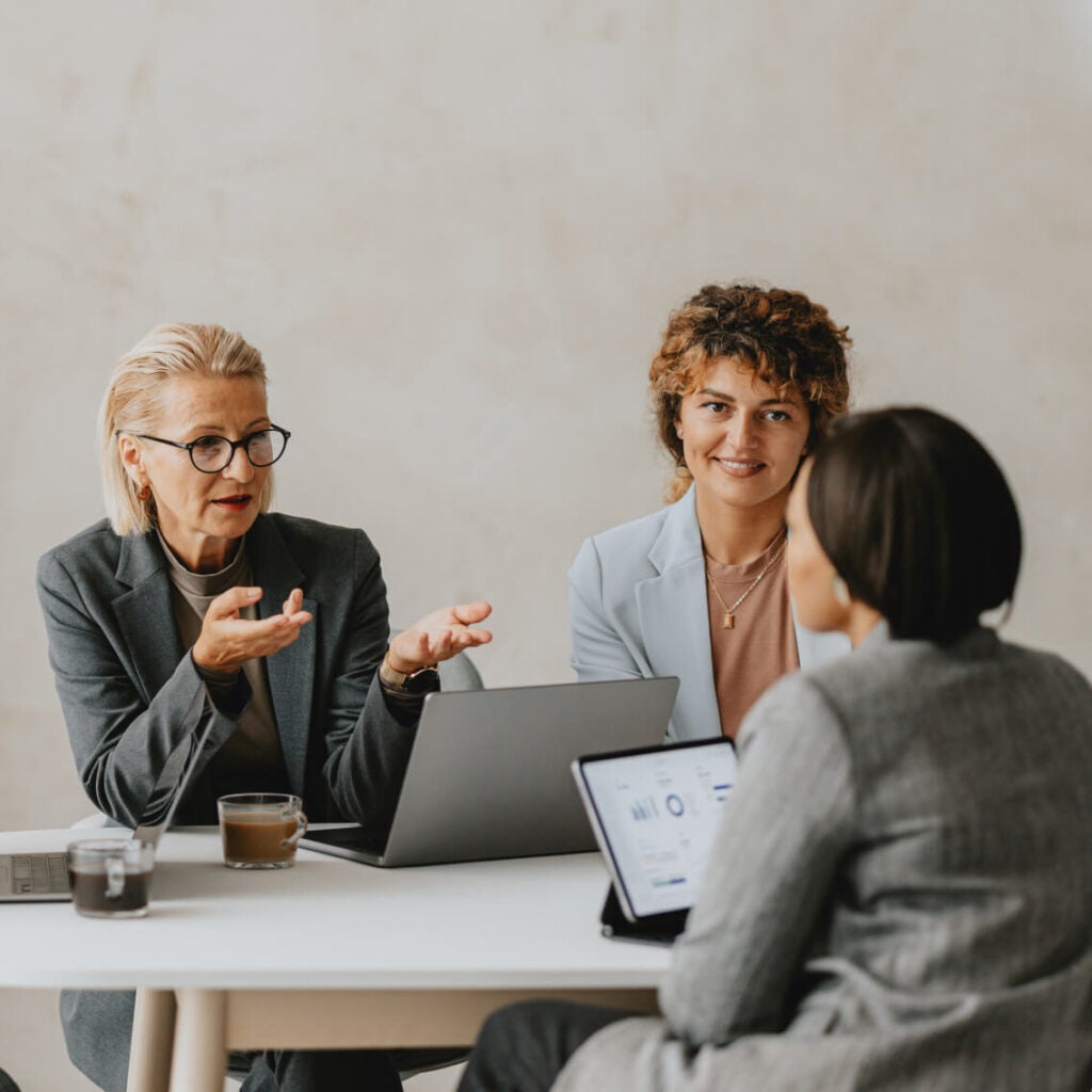 Three people in a meeting.