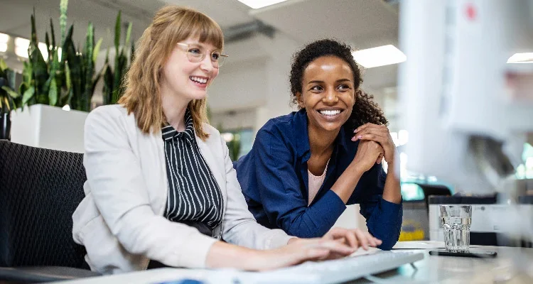 Two business women at a computer