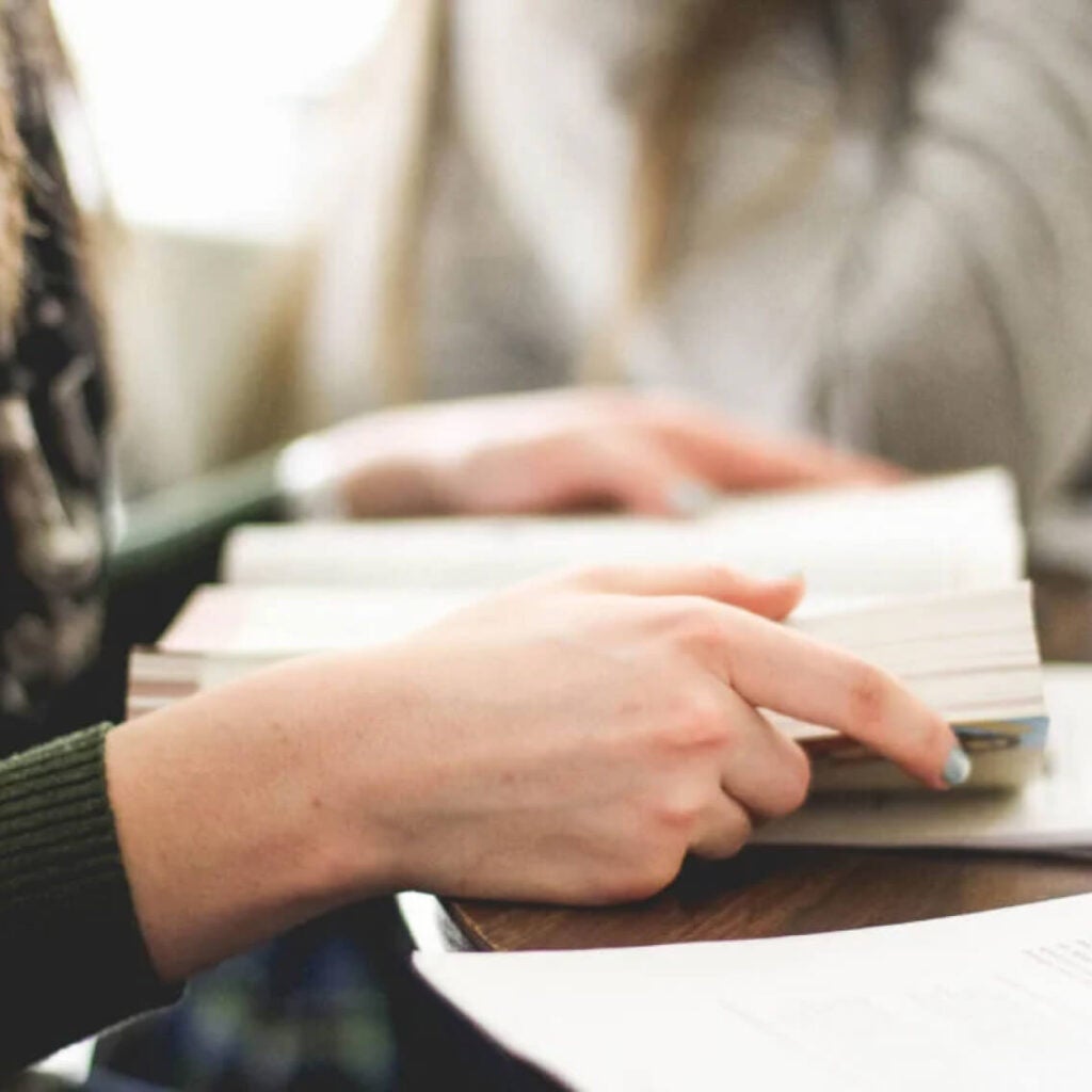 A close-up of someone holding open a book.