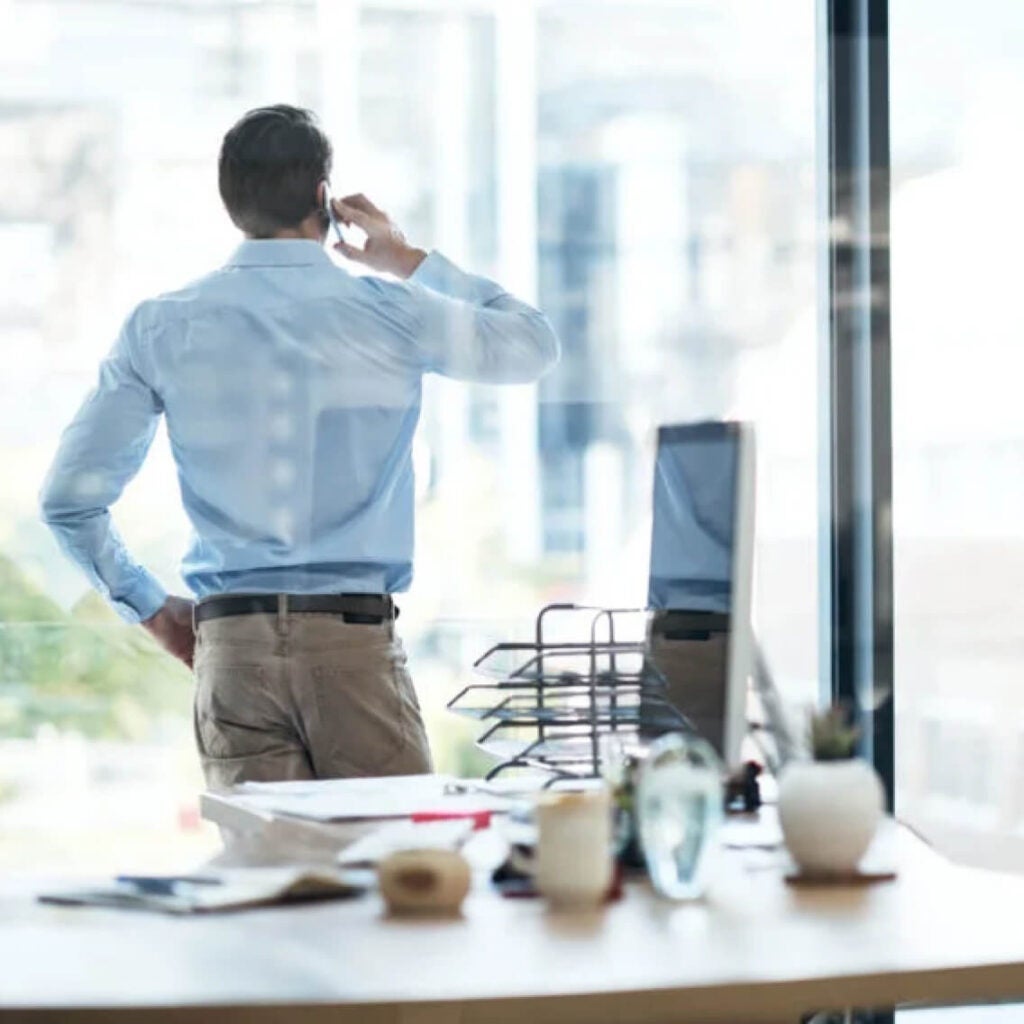 Someone taking a phone call at a window.