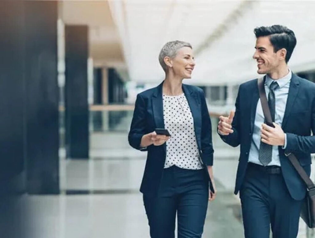 Two people talking in an office.