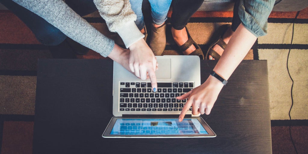 Photo of man looking at laptop