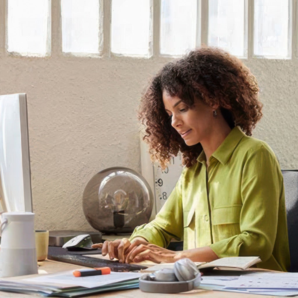 Woman at the office working at her computer workstation.